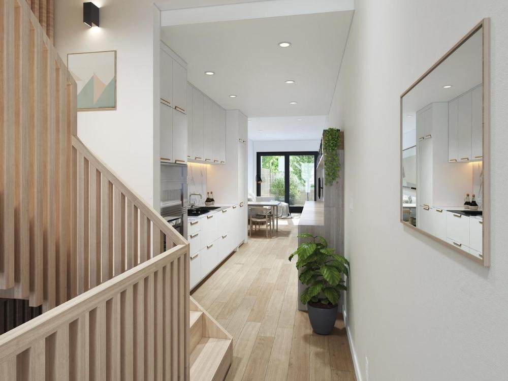 Khu bếp nhà phố 4x10m được thiết kế liền mạch, sử dụng tủ bếp chữ I tone sáng kết hợp mặt đá tự nhiên