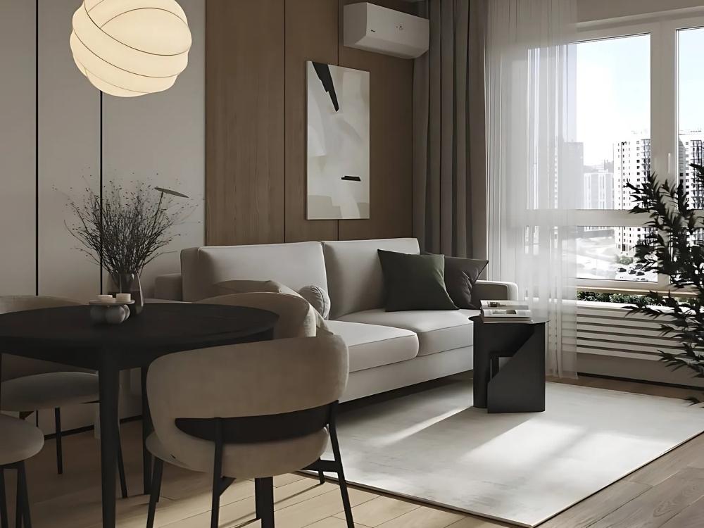 Phòng khách chung cư 43m2 với sofa xám, bàn trà kính và gương lớn tạo không gian rộng rãi và thoáng đãng.