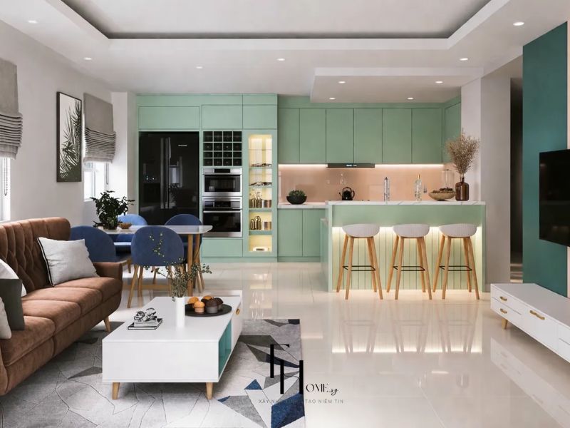 Phòng khách chung cư 100m2 3 phòng ngủ nhìn từ phía bếp sofa nhung caramel bàn trà trắng tủ TV trắng tay nắm vàng và bếp xanh mint kịch trần