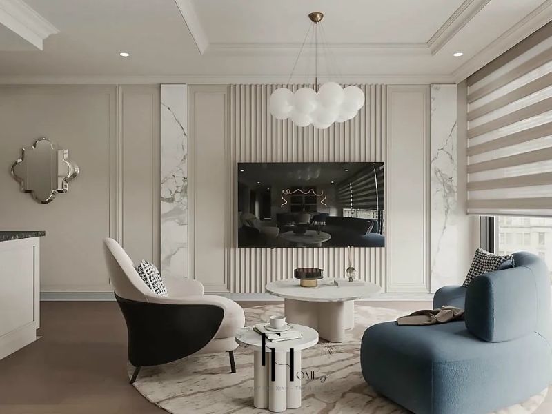 Phòng khách chung cư 55m2 phong cách Tân Cổ Điển với tường ốp phào trắng nan dọc, đèn thả bóng cầu trắng và sofa xanh cobalt