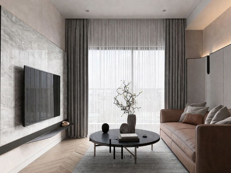 Phòng khách chung cư 45m2 phong cách tối giản sofa da nâu bàn trà tròn đen tường ốp đá xám rèm vải xám