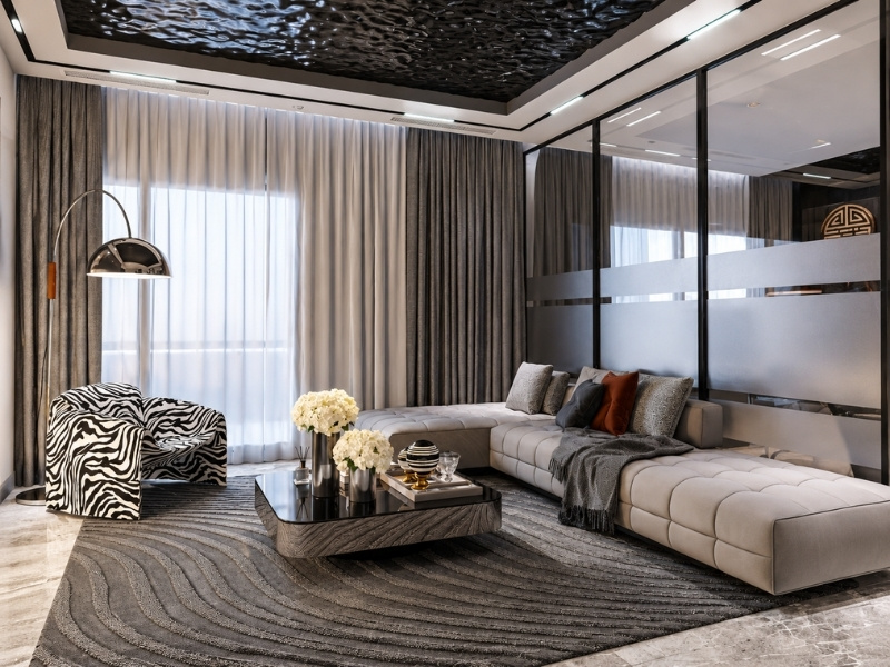Phòng khách hiện đại với vách kính khung đen dán mờ phân chia không gian phía sau sofa