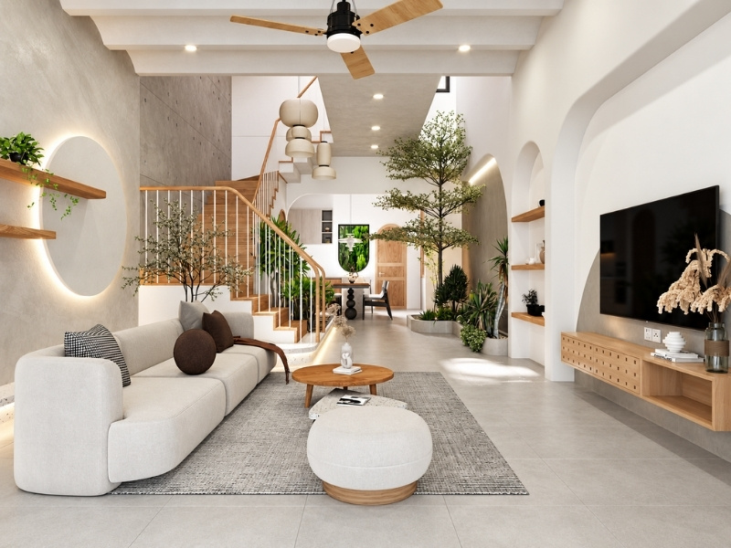 Phòng khách nhà phố Wabi Sabi thông thoáng với giếng trời cây xanh và sofa bo cong