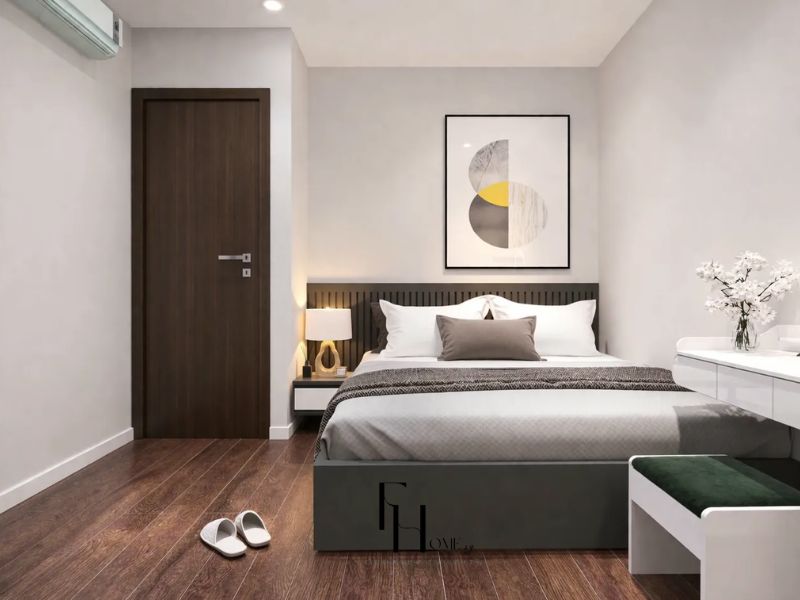 Phòng ngủ chính chung cư 100m2 2 phòng ngủ giường xám lam dọc tường trắng tranh hình học vàng xám bàn trang điểm trắng sàn gỗ nâu