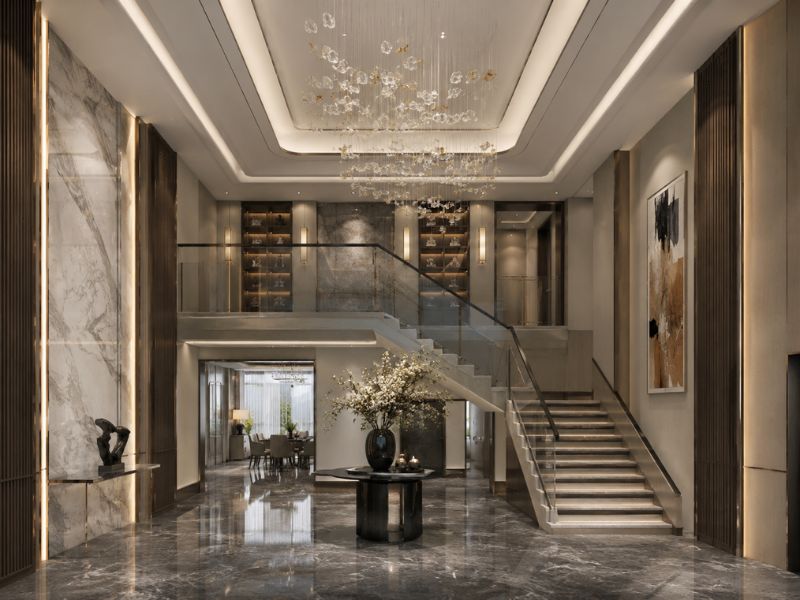 Sảnh thông tầng phong cách thiết kế nội thất Luxury với cầu thang lớn, sàn đá bóng, đèn thả nghệ thuật và hệ tủ trưng bày cao cấp