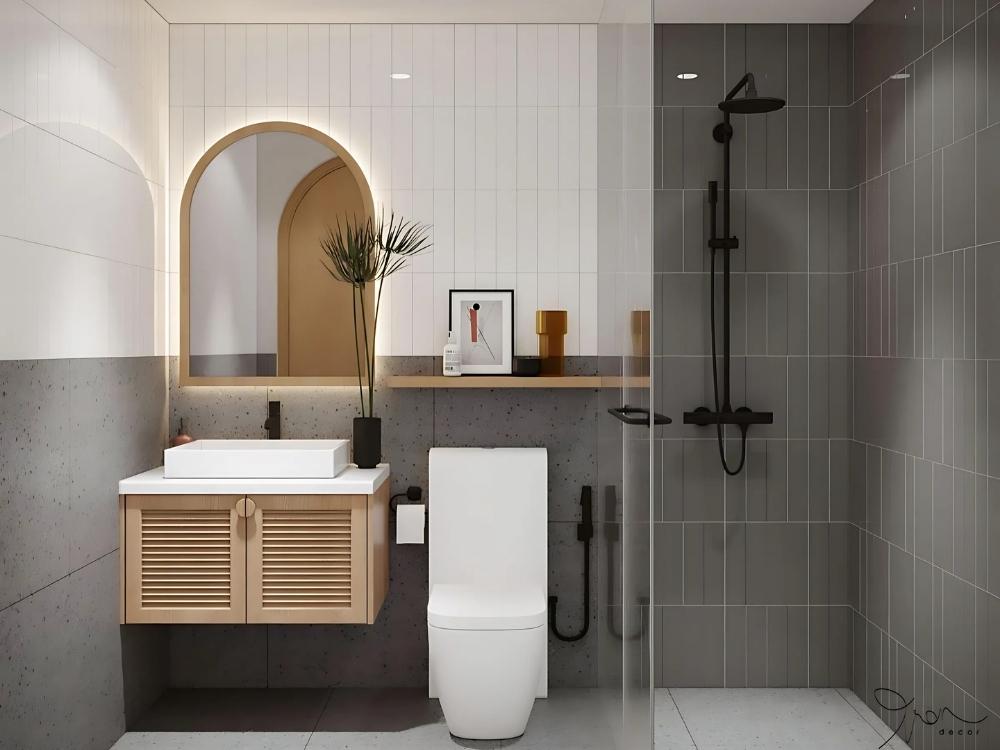 Phòng tắm kết hợp nhà vệ sinh với vách ngăn kính, bồn tắm và vòi sen hiện đại tạo không gian tiện nghi và thông thoáng.