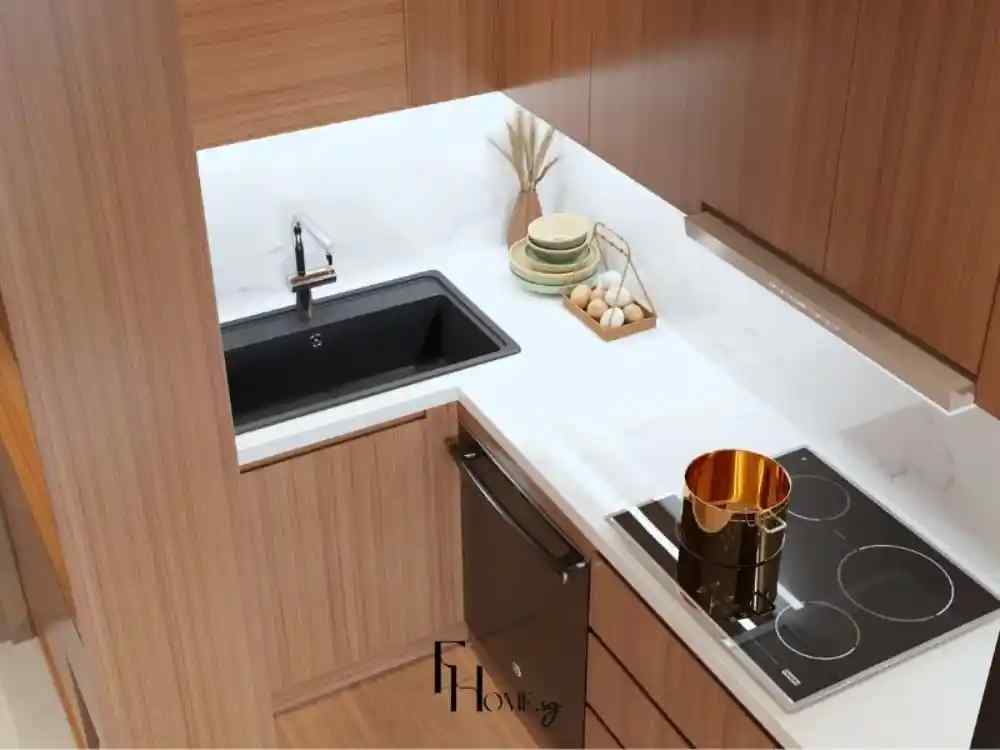 Góc bếp nhỏ gọn thiết kế hình chữ L với mặt bàn đá trắng tinh tế, bồn rửa màu đen nổi bật, bếp từ âm