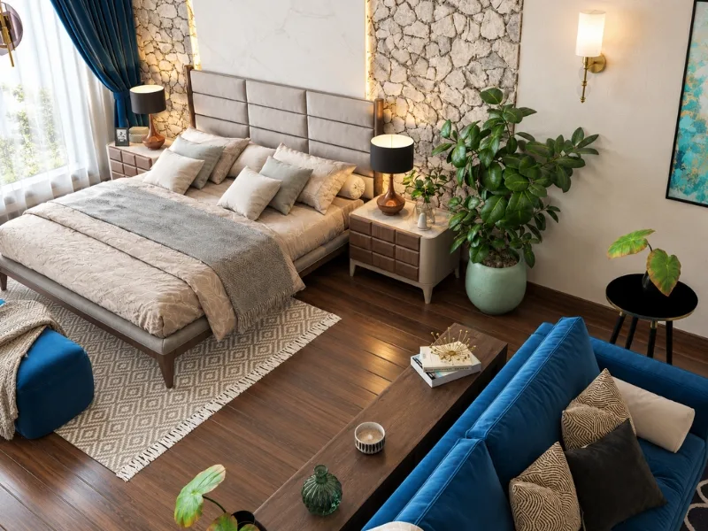 Không gian nghỉ ngơi phong cách Eco có giường be và ghế xanh trên sàn gỗ cạnh các chậu cây.