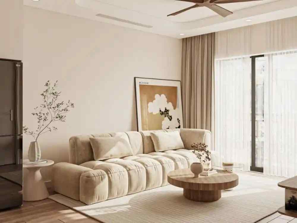 Không gian phòng khách Nhật Bản sáng, sofa nệm be, bàn tròn gỗ sồi, tranh tựa tường nhẹ nhàng