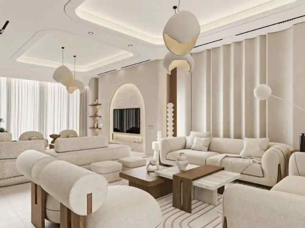 Không gian phòng khách tone kem sáng, nội thất bo tròn mềm mại kết hợp bàn gỗ và đèn trần độc đáo