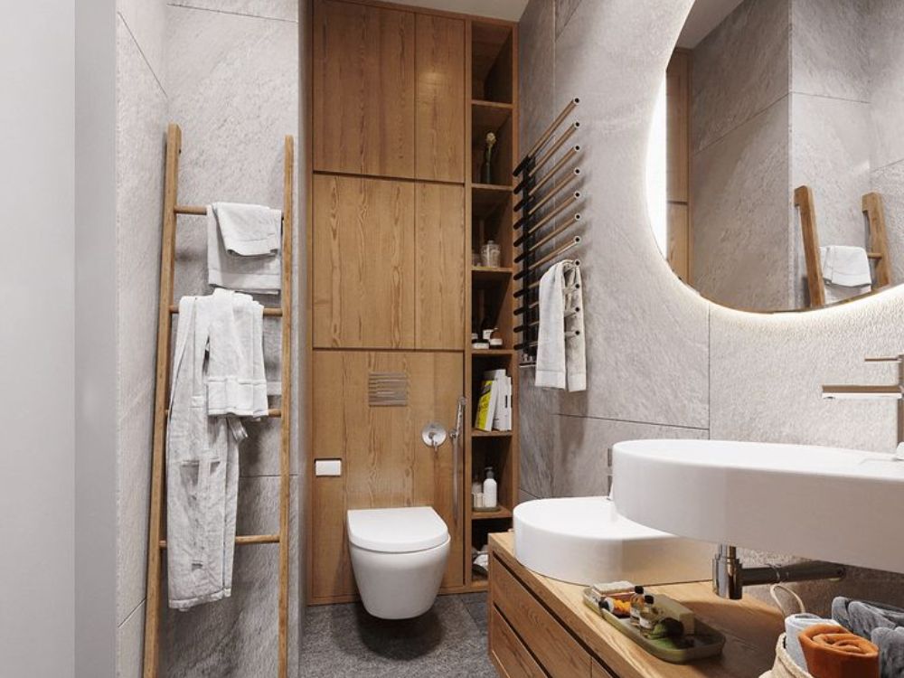 Nhà vệ sinh phong cách Nhật với tường đá xám, tủ gỗ sồi và gương đèn LED cong mềm mại