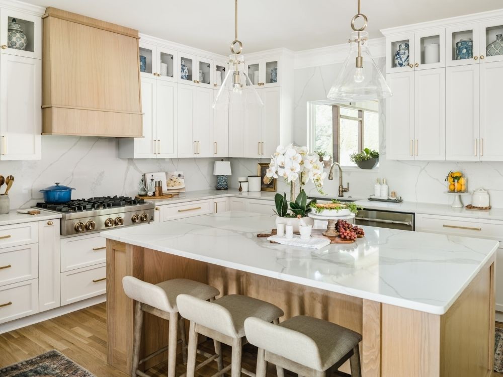 Phòng bếp hiện đại kết hợp gỗ sáng và đá marble trắng, đảo bếp lớn trung tâm