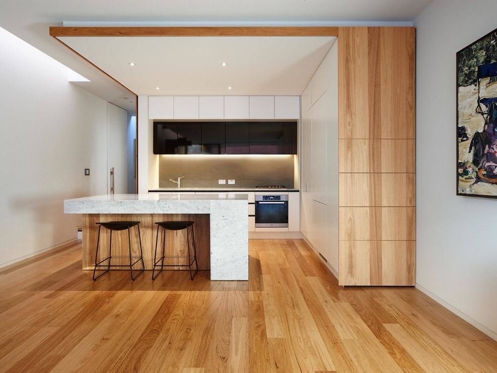 Phòng bếp phong cách Nhật Bản với quầy bếp trung tâm phủ đá sáng, gỗ tự nhiên