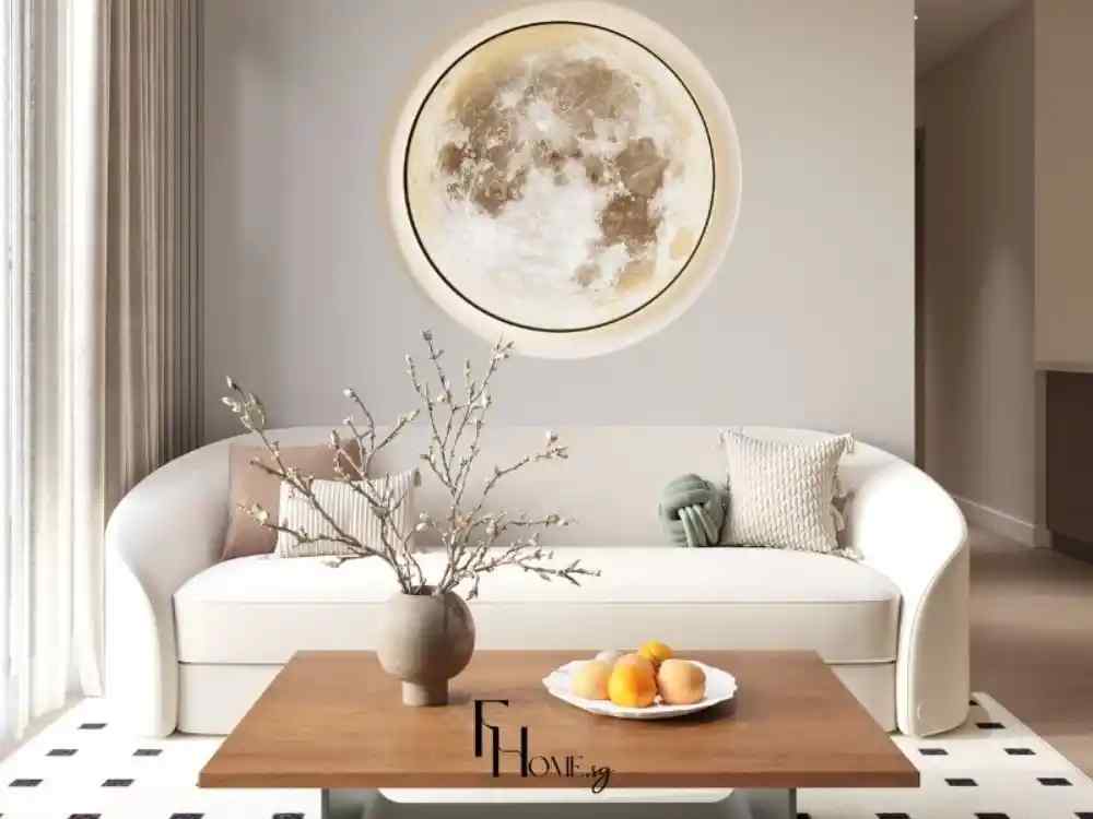 Phòng khách hiện đại với sofa cong trắng, bàn gỗ và tranh mặt trăng treo tường nổi bật.