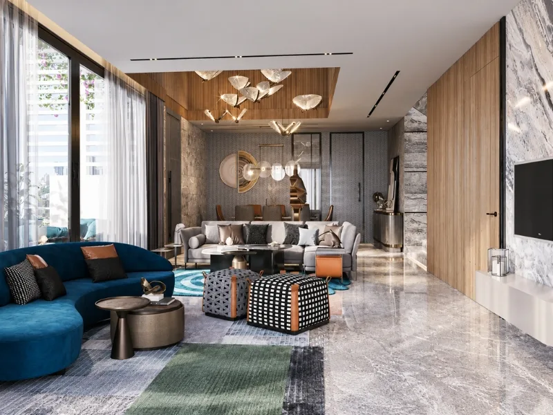 Phòng khách phong cách Luxury bố trí sofa xanh đậm dưới đèn thả nghệ thuật trên sàn đá bóng.