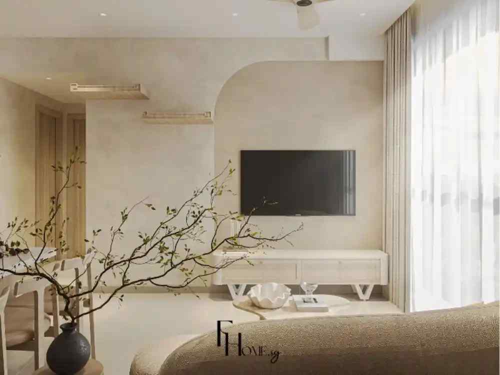 Phòng khách phong cách Wabi Sabi với tường sơn be nhạt, kệ TV gỗ sáng, sofa vải nâu sáng và rèm trắng mỏng