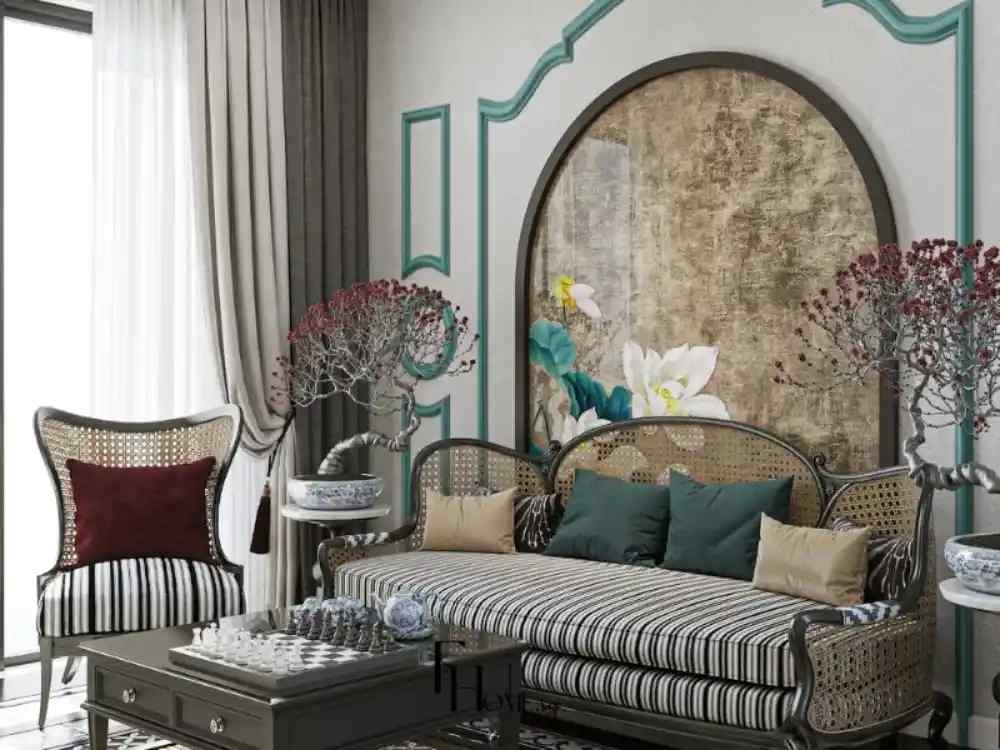 Phòng khách theo phong cách Indochine với sofa mây phối đệm kẻ sọc, phông nền hoa sen và chậu bonsai trang trí hai bên