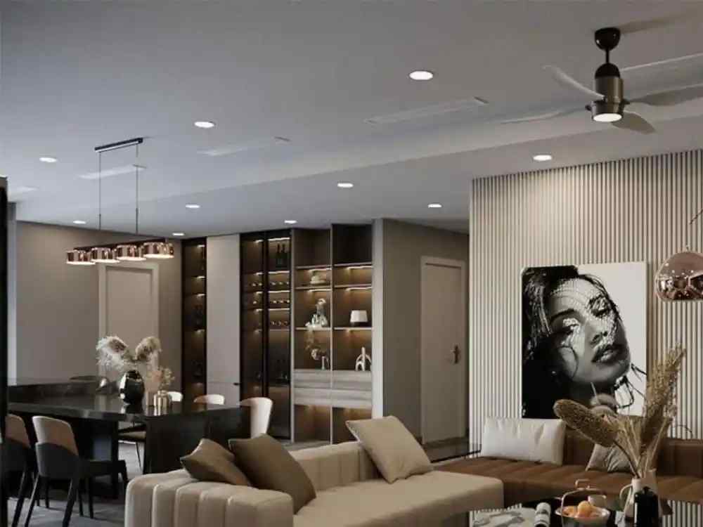 Phòng khách theo phong cách Luxury với sofa da xám sang trọng, tường ốp gương và đèn trần pha lê lớn