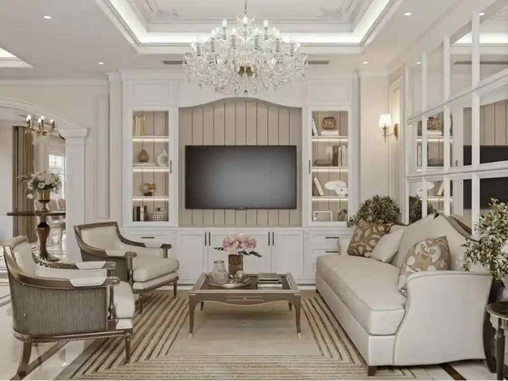 Phòng khách theo phong cách tân cổ điển với sofa kem, đèn chùm pha lê và tủ tivi viền vàng