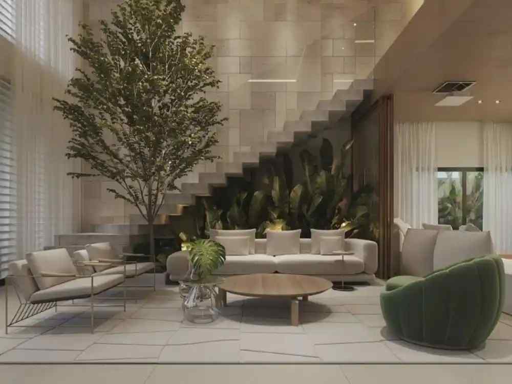 Phòng khách theo phong cách tối giản với sofa trắng, ghế xanh rêu, cây xanh lớn cạnh cầu thang kính