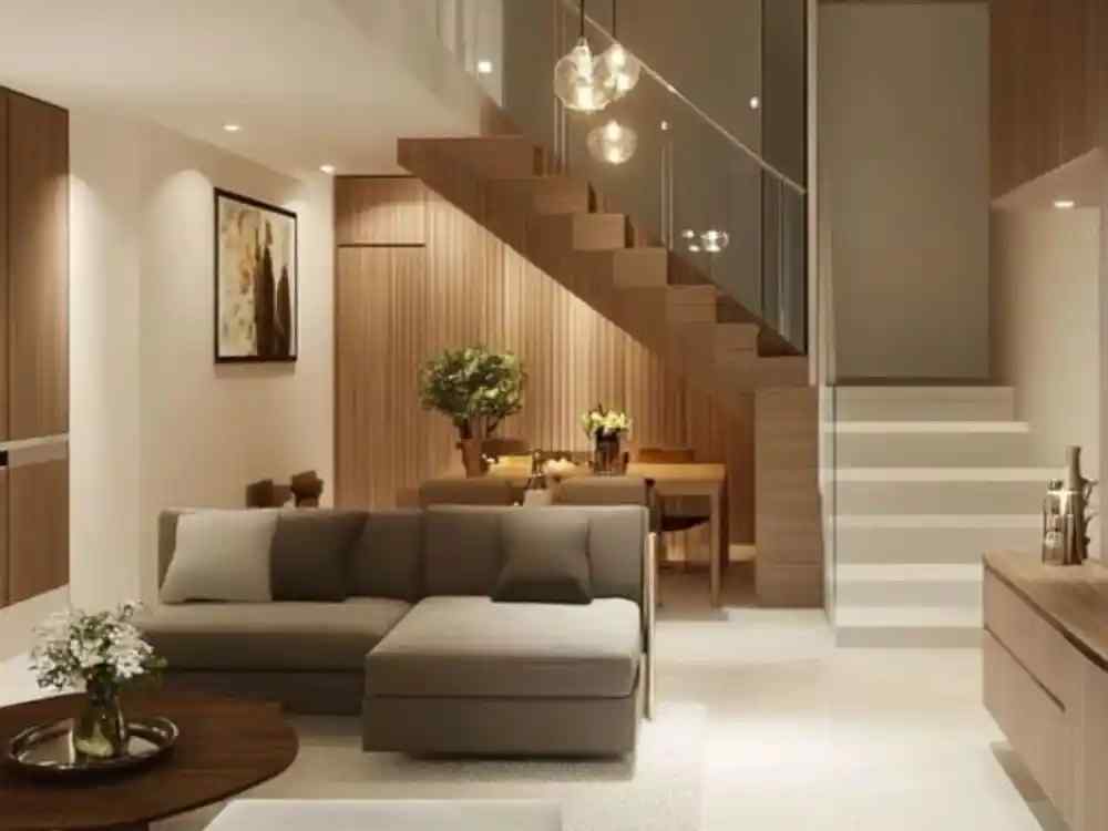 Phòng khách theo phong cách tối giản với sofa xám chữ L, cầu thang gỗ, ánh sáng vàng ấm
