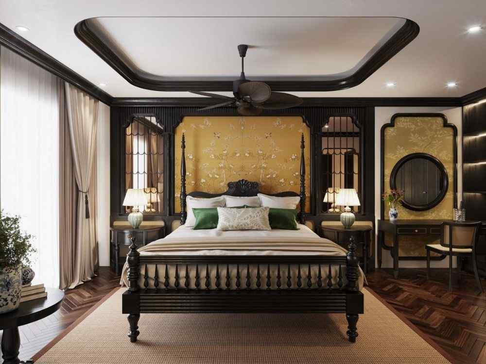 Phòng ngủ Indochine đậm nét Á Đông, tường vàng họa tiết hoa lá, giường gỗ chạm trổ,
