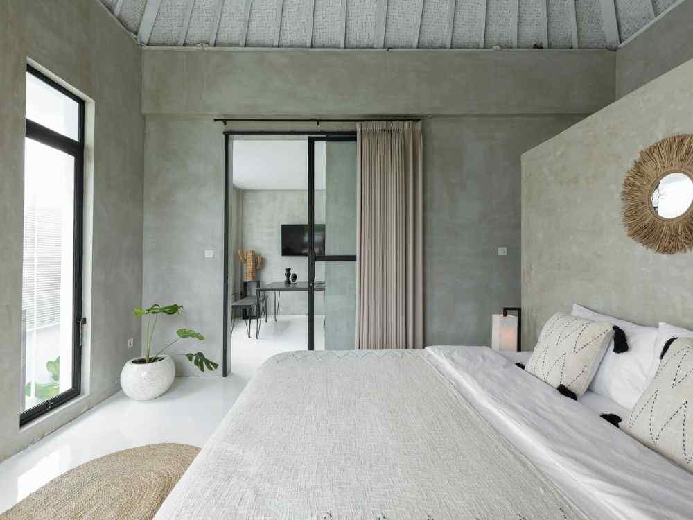 Phòng ngủ phong cách hiện đại pha Wabi Sabi, tường bê tông xám, nội thất mộc, ánh sáng nhẹ