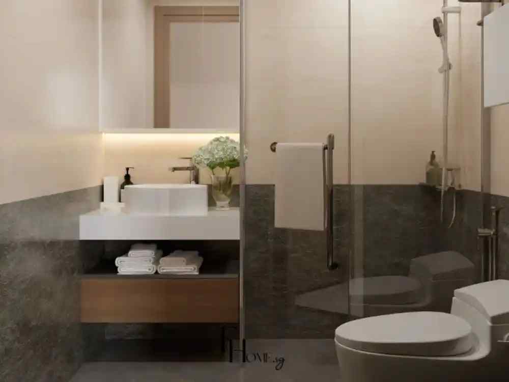 Phòng tắm hiện đại tông màu kem và xám đậm, bồn rửa tròn đặt trên kệ nổi trắng, có đèn hắt sáng dưới gương