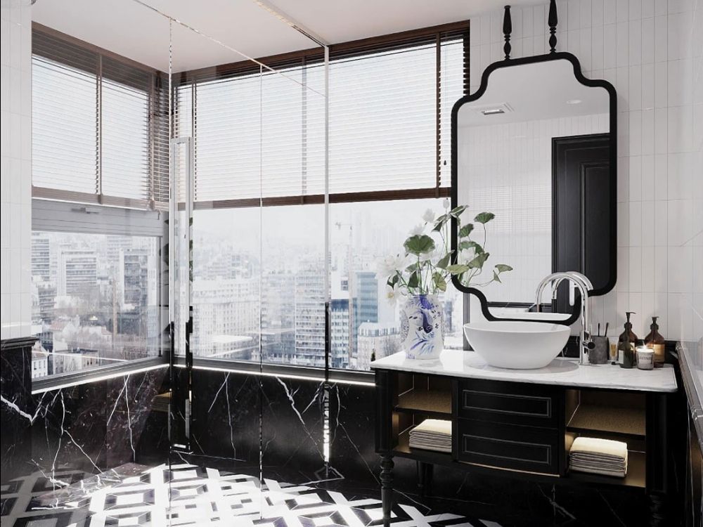 Phòng tắm Indochine hiện đại với sàn đá đen vân trắng, gương viền đen uốn lượn và cửa sổ lớn đón sáng tự nhiên