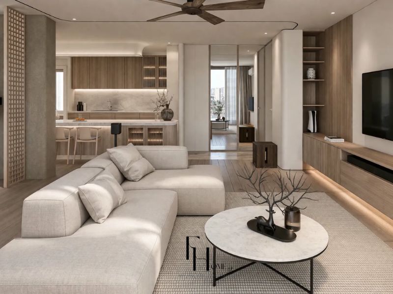 Phòng khách tối giản sử dụng sofa chữ L, bàn trà tròn mặt đá, kệ tivi gỗ treo tường và không gian liên thông bếp trong thiết kế nội thất căn hộ 90m2