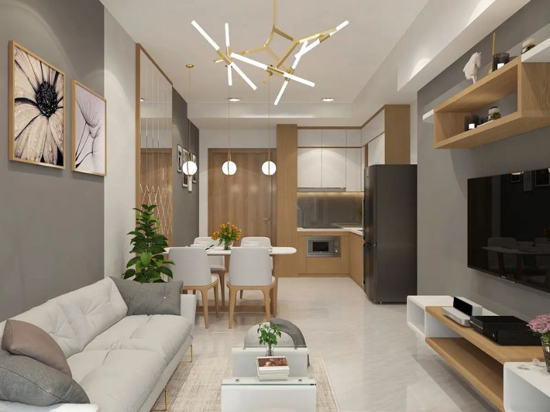 Không gian khách bếp chung cư 55m2 bố trí sofa, bàn ăn và cây xanh theo lối đi thông thoáng