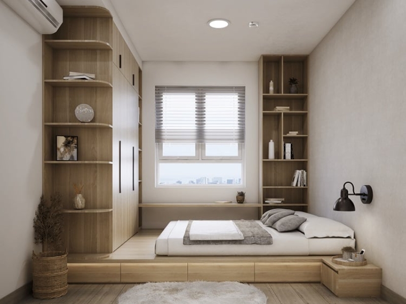 Phòng ngủ chung cư phong cách Nhật Bản với giường thấp trên bục gỗ, ngăn kéo và tủ kệ sát tường