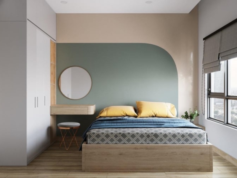 Mẫu nội thất phòng ngủ chung cư 10m² với tường bo cong xanh rêu và gối vàng chăn navy 