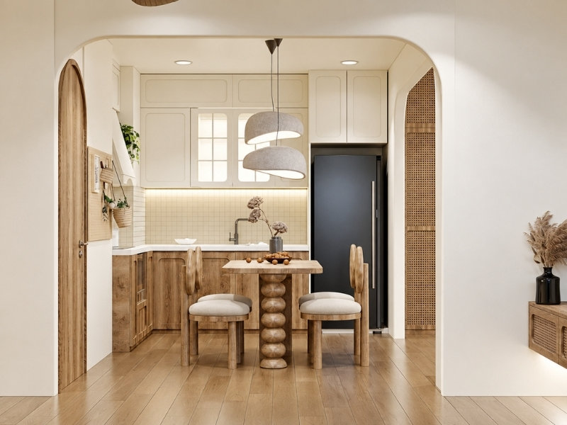 Phòng bếp căn hộ 35m2 với tủ bếp sát tường, bàn ăn nhỏ và lối đi vòm cong