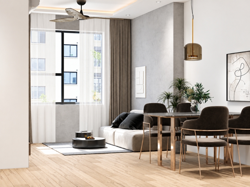Góc nhìn phòng khách và bàn ăn căn hộ tối giản với sofa sáng màu, bàn gỗ, ghế nâu và cửa sổ lớn.