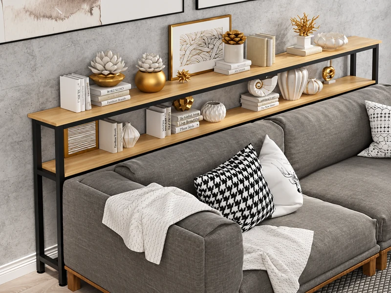Kệ sách gỗ đặt sát lưng sofa màu xám, trưng bày sách và đồ trang trí trong phòng khách