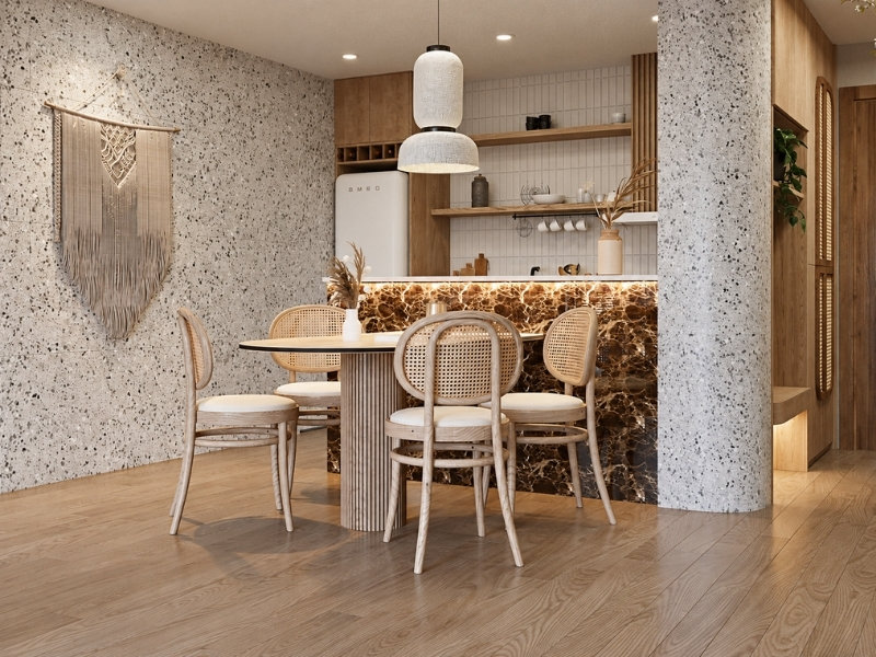Khu bếp Wabi Sabi với bàn ăn mây, tủ gỗ và tường đá terrazzo