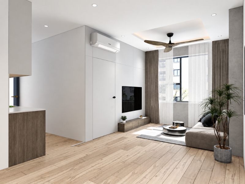 Phòng khách căn hộ 2 phòng ngủ tối giản với sofa, sàn gỗ sáng và cửa sổ lớn.