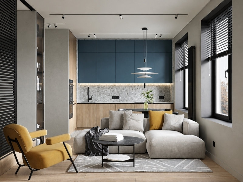 Căn hộ 40m2 với phòng khách liên thông bếp, sofa module, tủ gỗ và mảng tường xanh lam