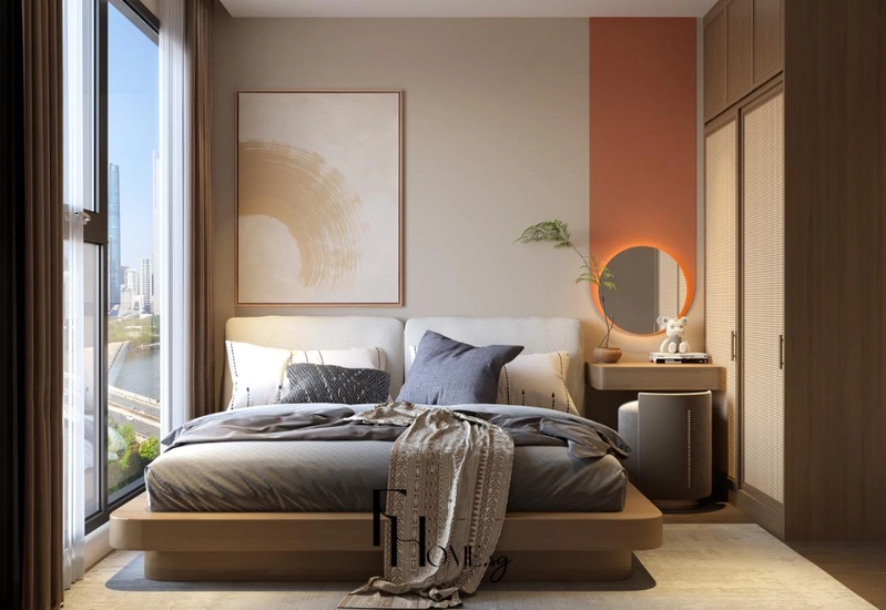 Giường bục và gương tròn viền đèn trước mảng tường cam đất trong phòng ngủ