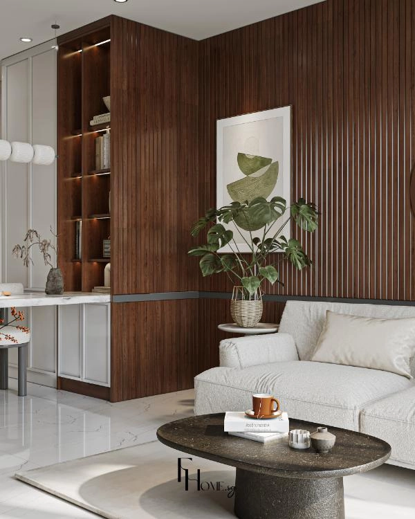 Mảng lam sóng gỗ nâu trầm cạnh kệ mở có đèn và sofa kem