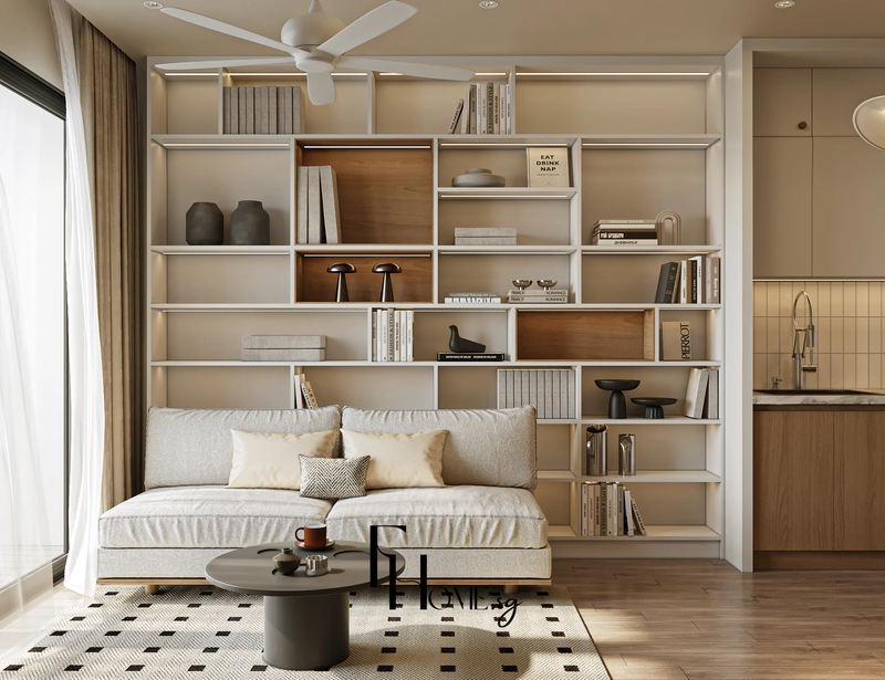 Sofa vải trắng kem kê sát kệ sách trắng và bàn trà tròn